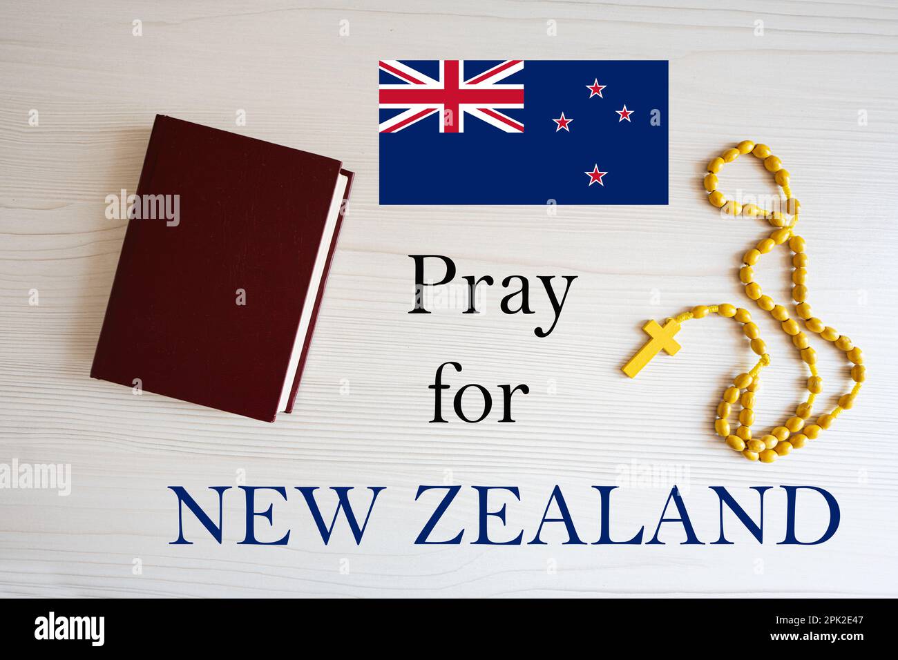 Pray for New Zealand. Rosary and Holy Bible background. Stock Photo