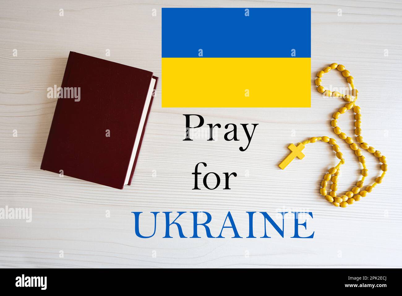 Pray for Ukraine. Rosary and Holy Bible background. Stock Photo