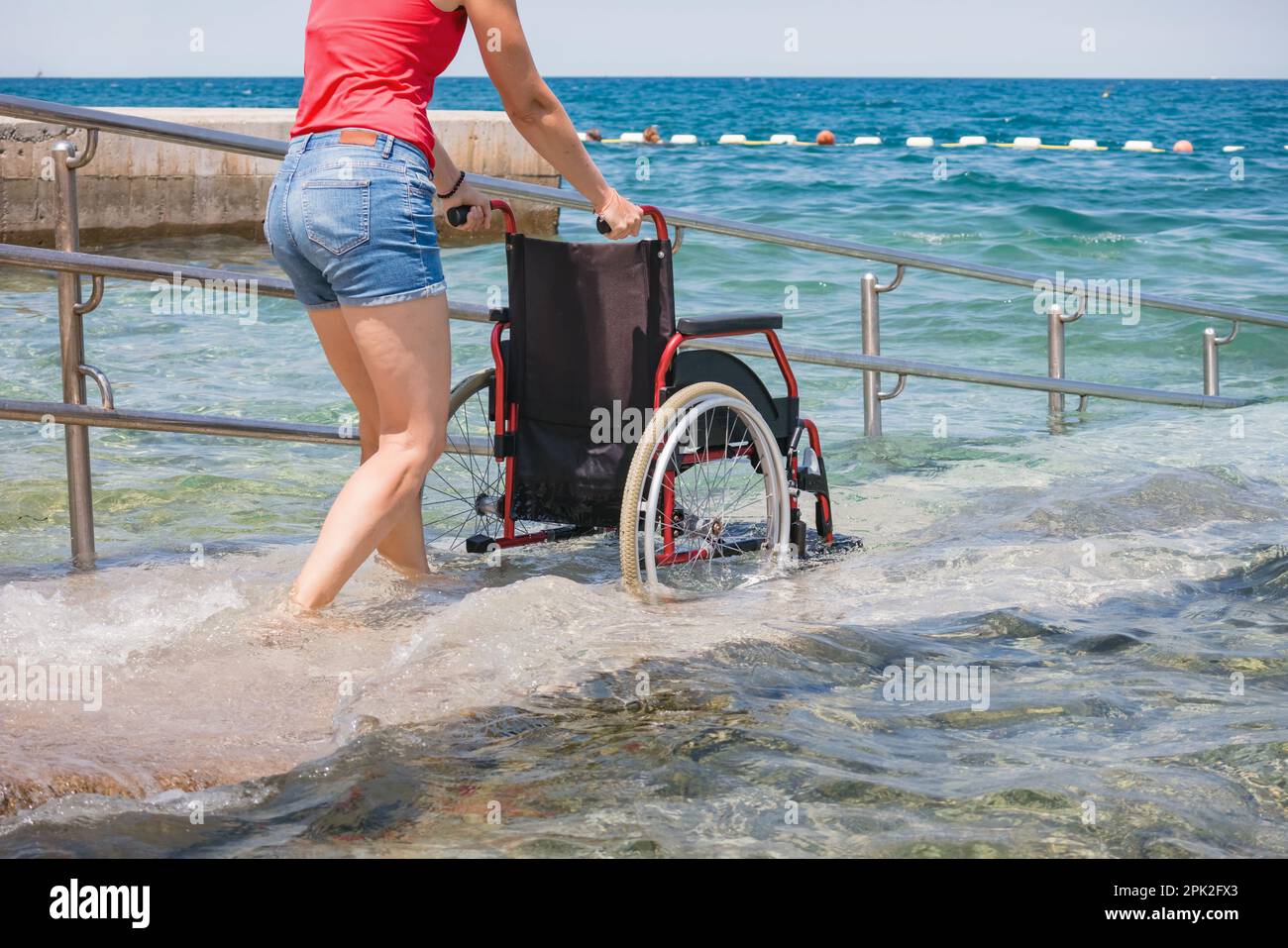 Accessible beach with wheelchair with ramp for persons with disability ...