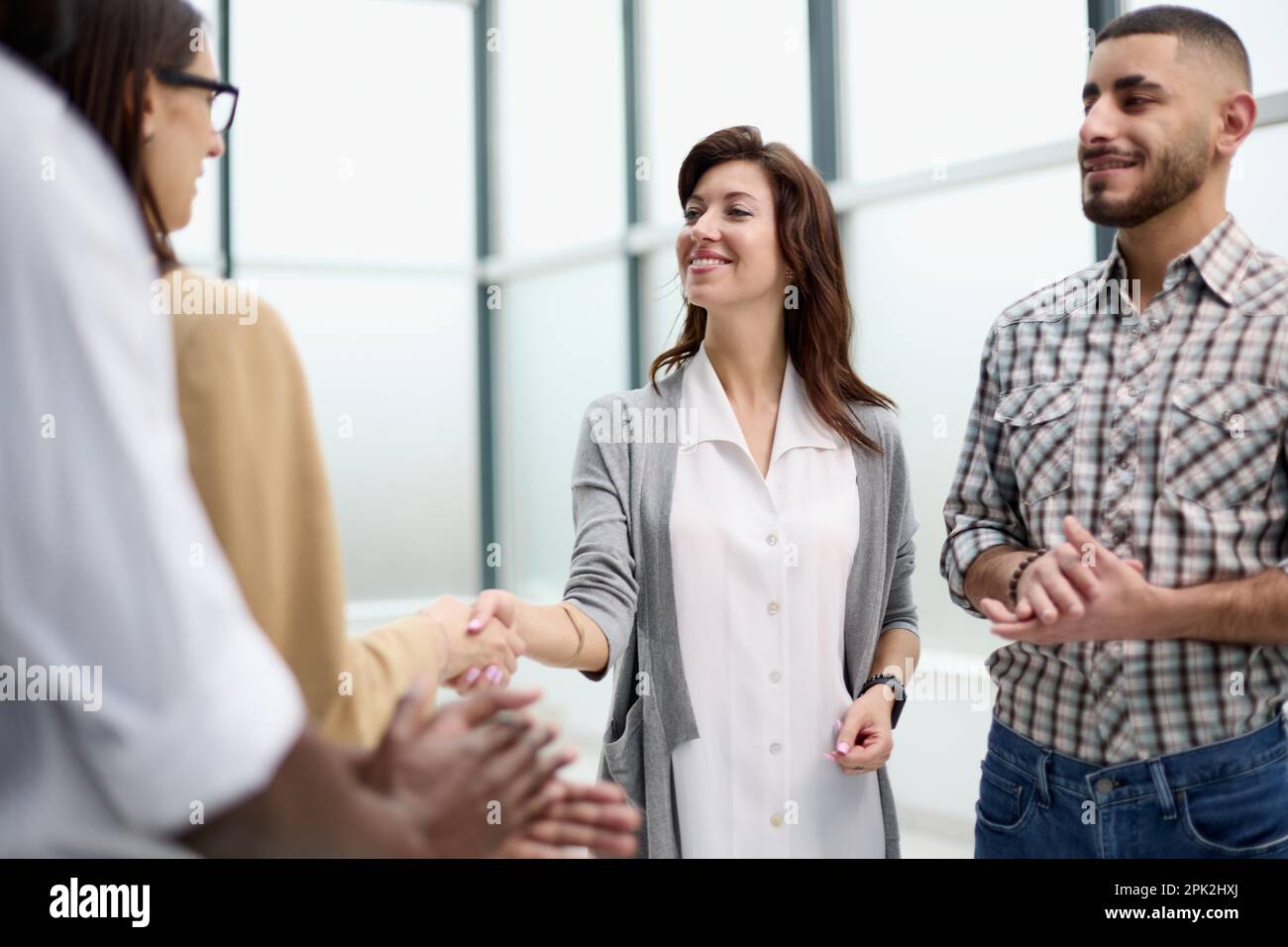 Laughing multiethnic business people talking in the office Stock Photo ...