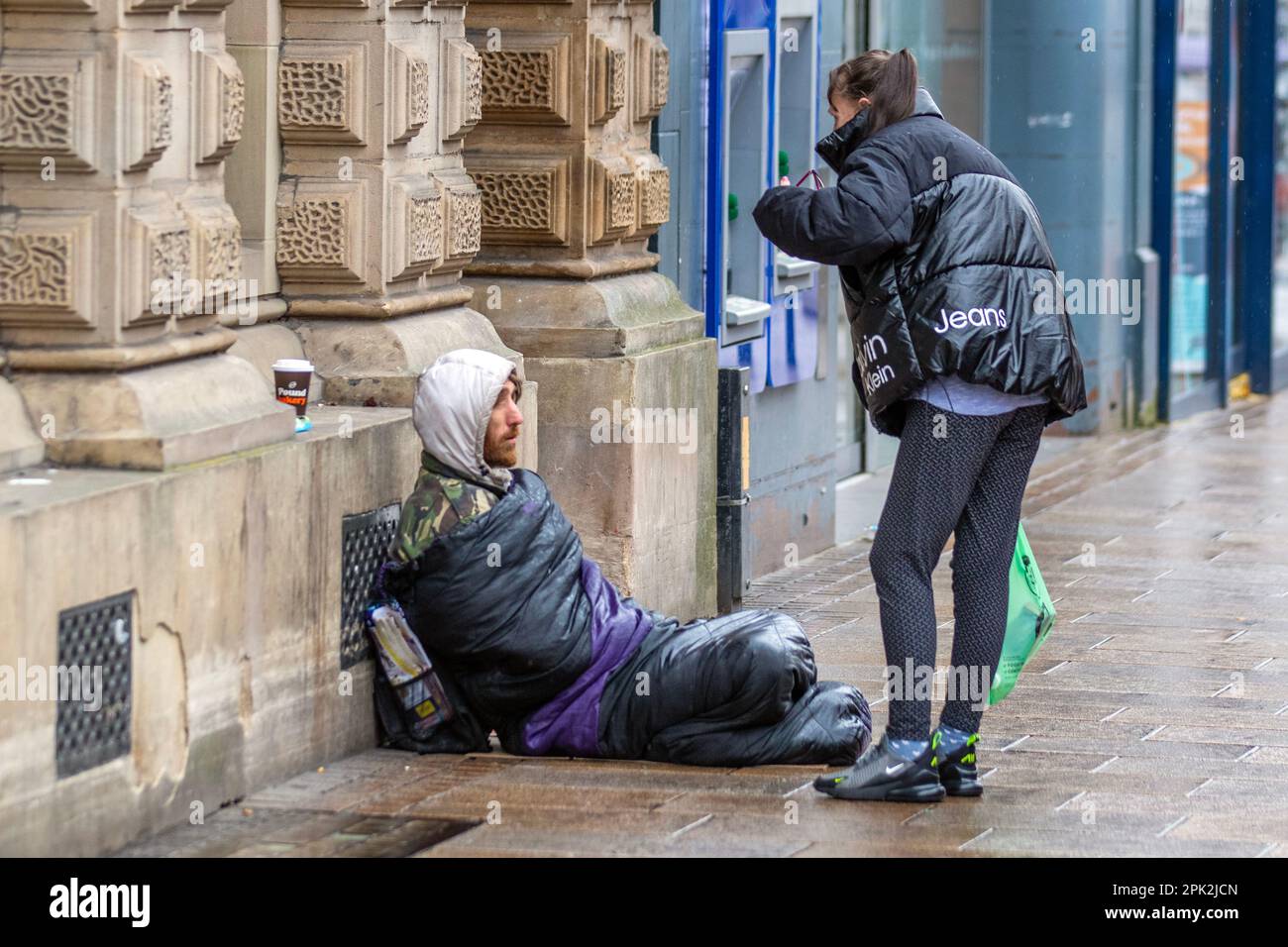 PRESTON, Lancashire.  Uk Weather. Homeless people,  Shops, shoppers on a rainy day in the city centre.  Outbreaks of rain pushing eastwards but gradually clearing from the northwest. Credit MediaWorldImages/AlamyLiveNews Stock Photo