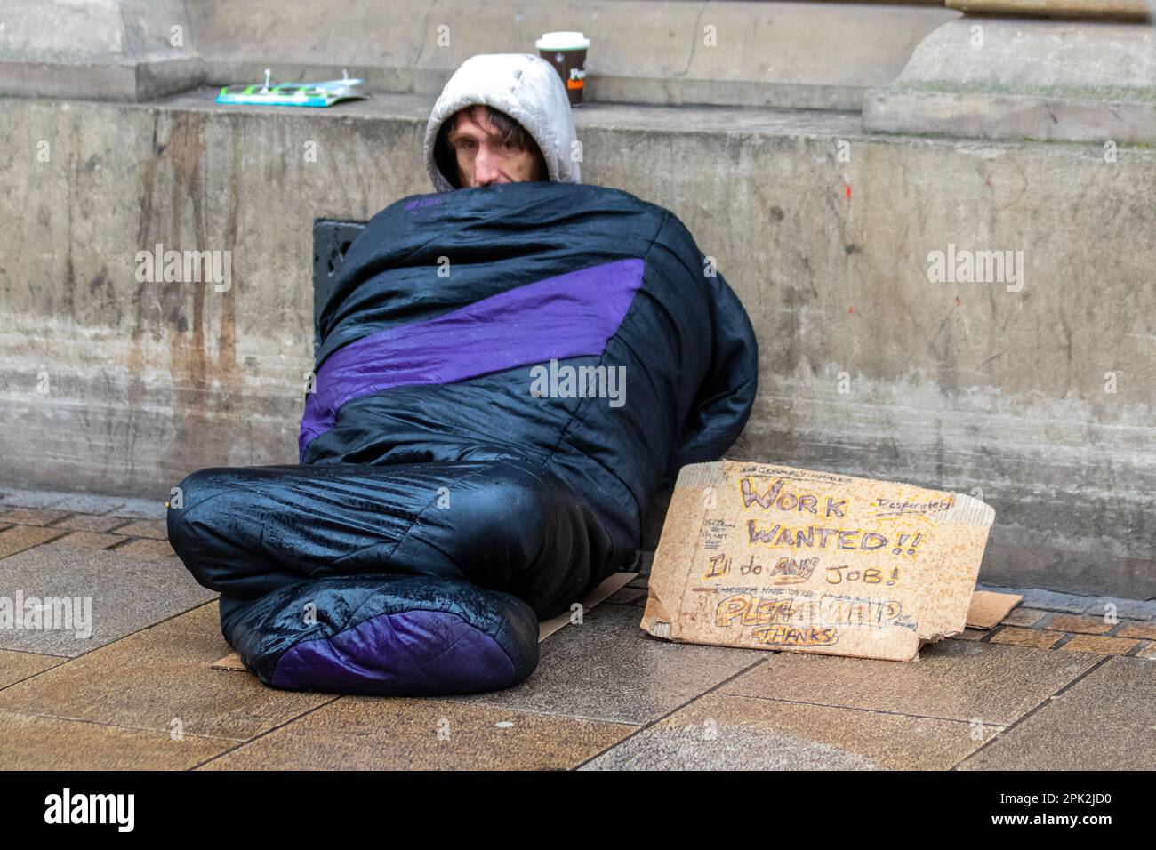 PRESTON, Lancashire.  Uk Weather. Homeless people,  Shops, shoppers on a rainy day in the city centre.  Outbreaks of rain pushing eastwards but gradually clearing from the northwest. Credit MediaWorldImages/AlamyLiveNews Stock Photo
