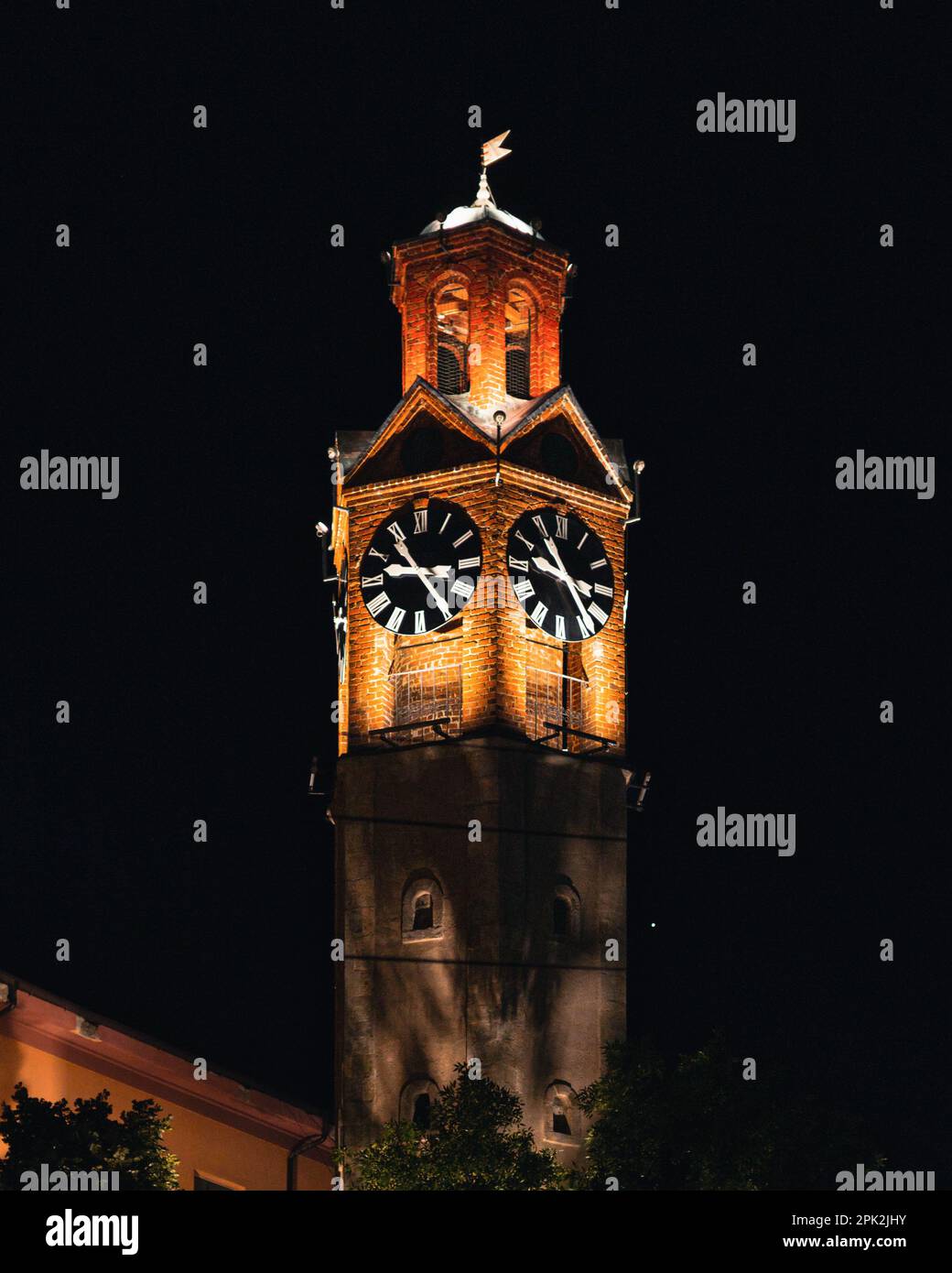 A highrise building with a clock tower adorning its rooftop Stock