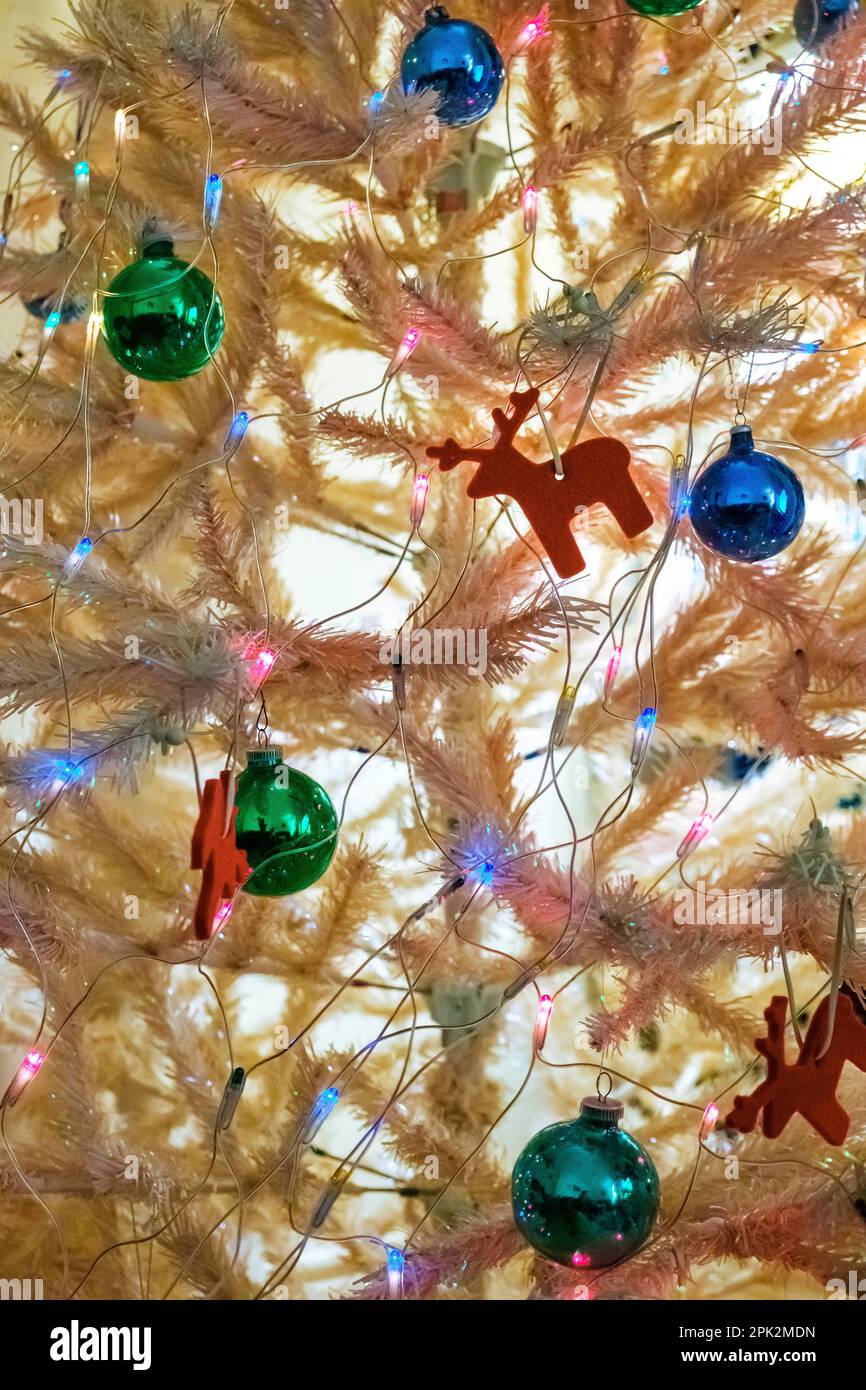 Details of a white tinsel Christmas tree with decorations Stock Photo