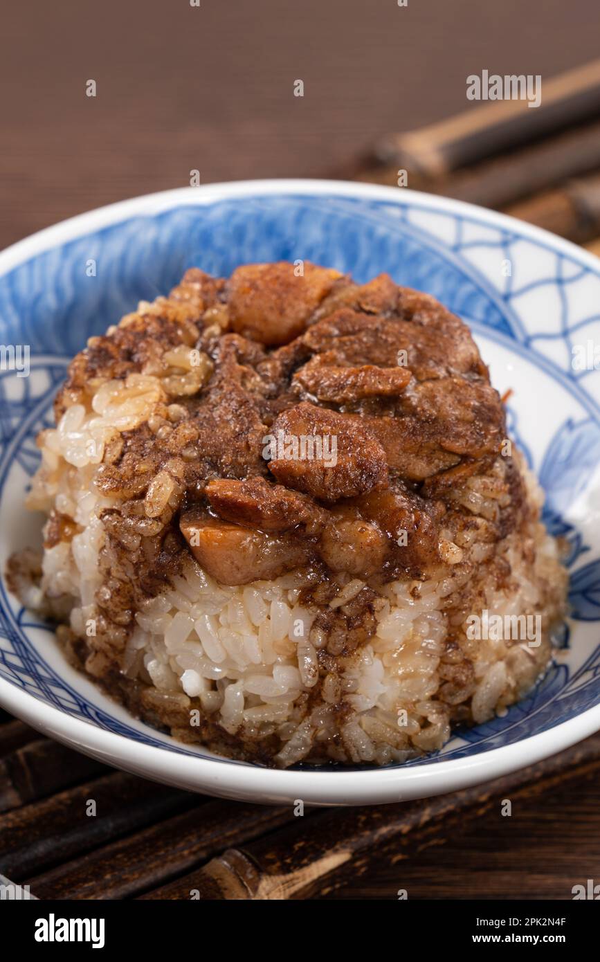 Migao, tube rice cake, rice pudding in a bowl topped with minced pork, delicious Taiwanese street food. Stock Photo
