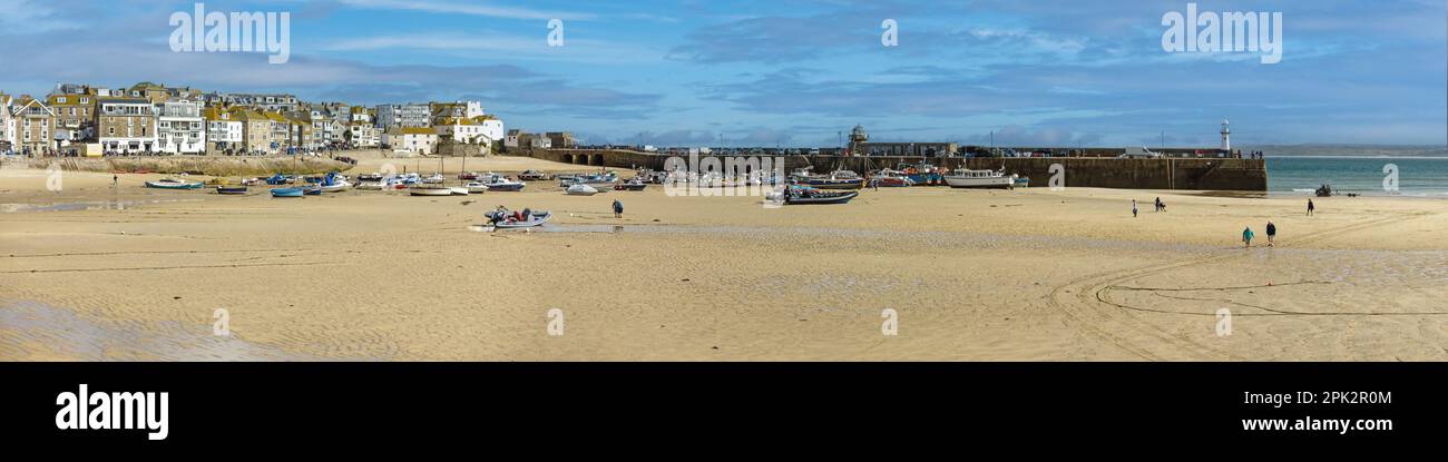 Ultra wide panoramic view of sandy beach and quayside of St. Ives harbour at low tide in September, Cornwall, England, UK Stock Photo
