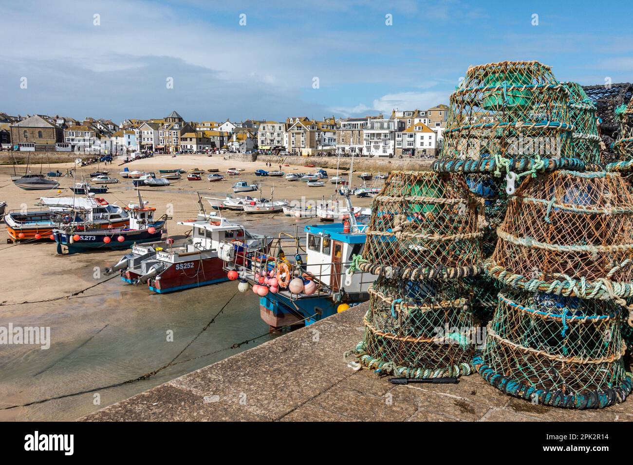 Lobster pots / creels on the quayside of St. Ives harbour at low tide in September, Cornwall, England, UK Stock Photo