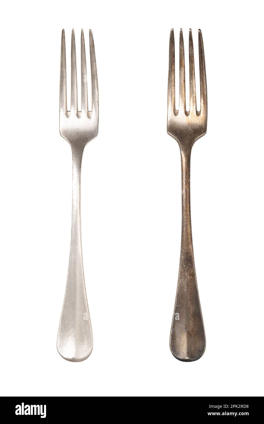 Polished and tarnished sterling silver fork handles, old and often used. Hydrogen sulfide and oxygen in the air react with layers of the metal. Stock Photo