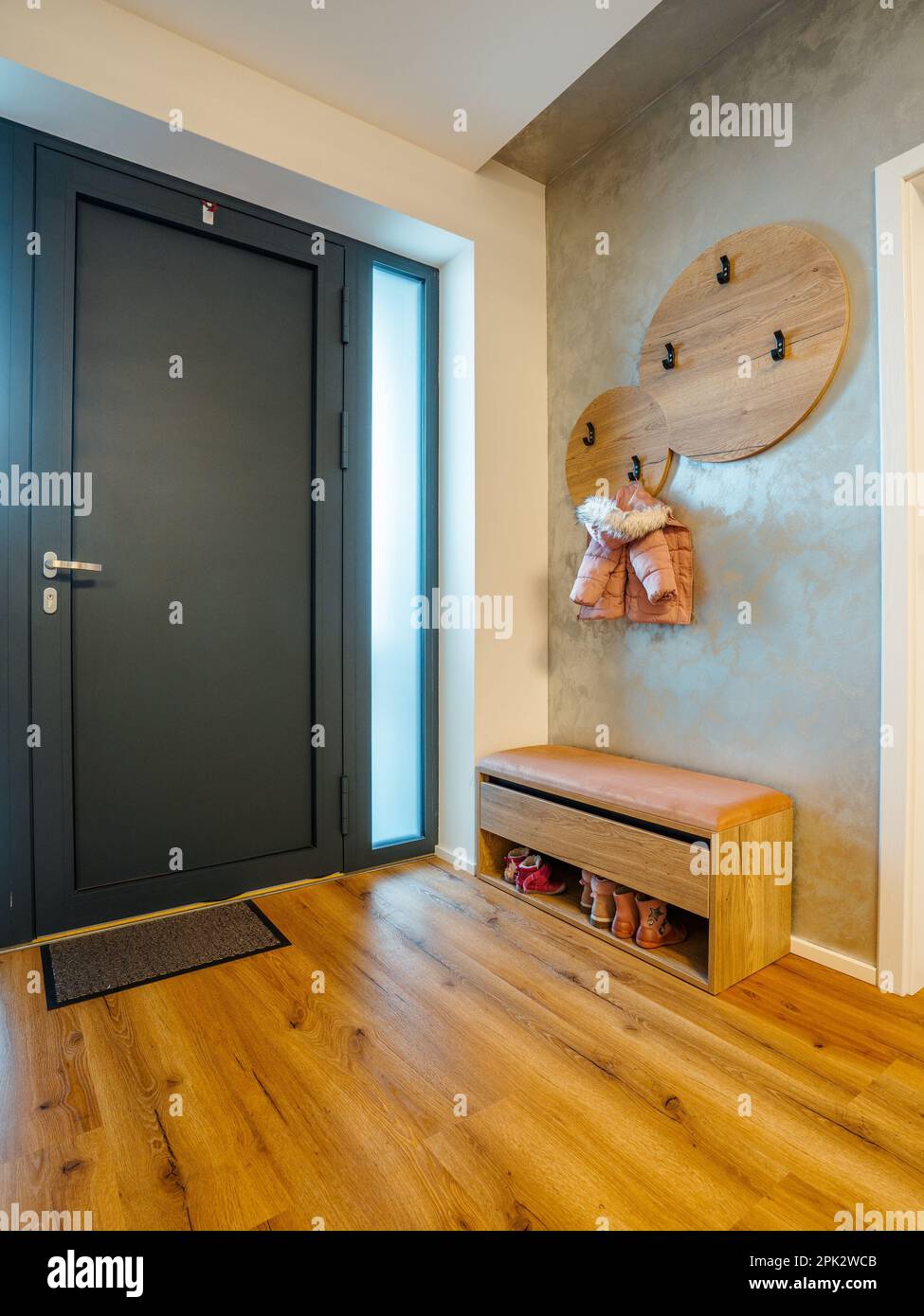 An inviting interior hallway with a tastefully polished wooden floor ...