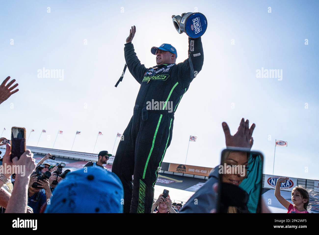Pomona, United States. 02nd Apr, 2023. Matt Hagan holds up his trophy after taking the win in the Top Fuel division of the Lucas Oil Winternationals. Professional Drag racers nationwide rally together to compete at the Lucas Oil NHRA Winternationals held at the In-N-Out Burger Pomona Dragstrip for the 63rd consecutive year. Drivers battled over a three-day period starting on March 31st and concluding on April 2, fighting to take the titles in each of their divisions. Credit: SOPA Images Limited/Alamy Live News Stock Photo