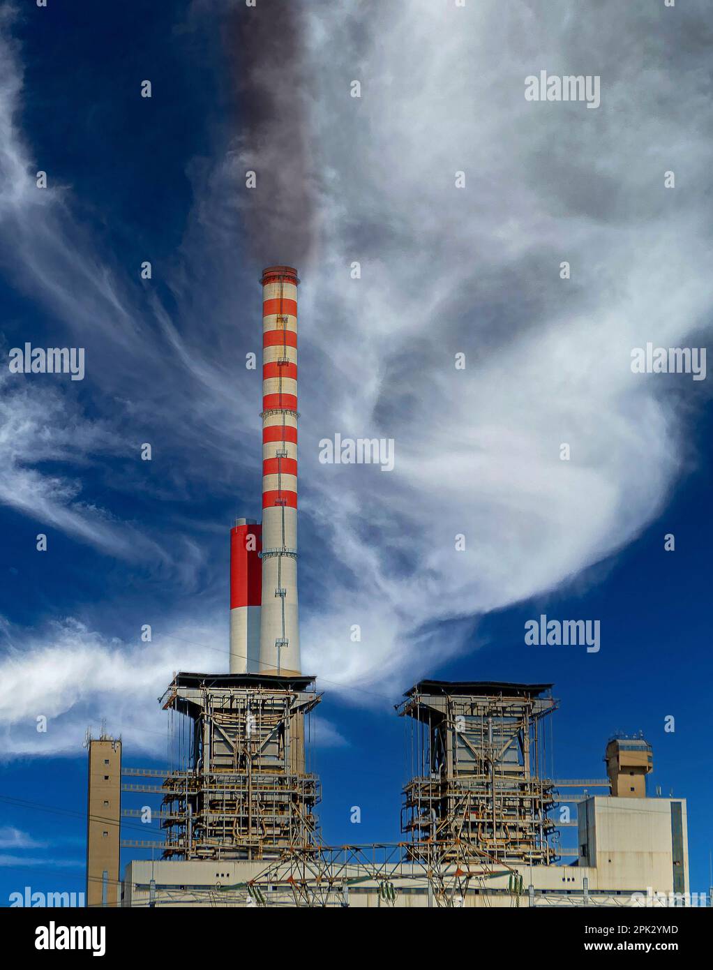 Industrial coal power plant with tall chimney ejecting dark smoke