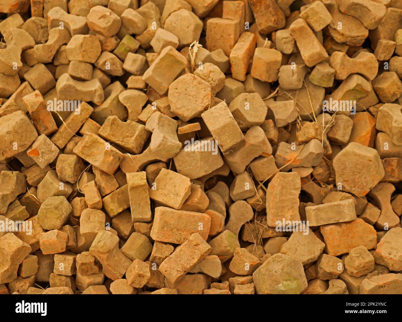 Large pile of recycled stone bricks materials used for making pavement