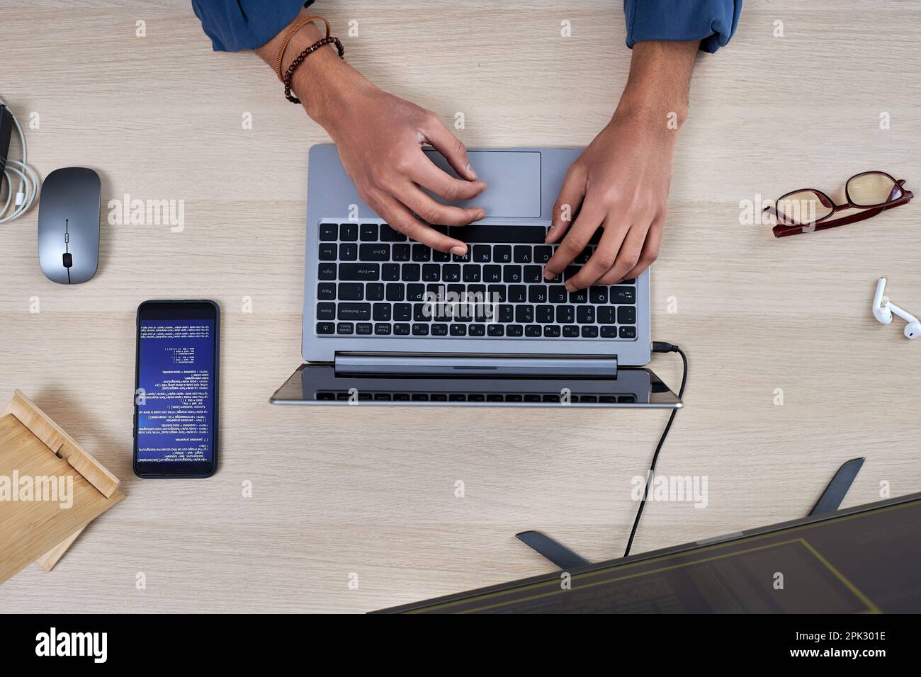 Minimal top view at male hands typing on keyboard and writing code for mobile app Stock Photo