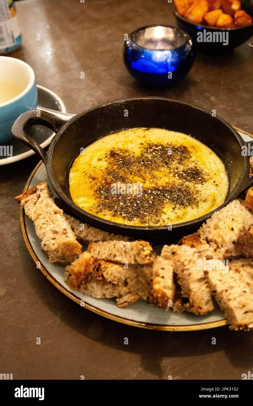 Turkish cheese fondue with za'atar spice at Megan's at the Battersea Power Station, London, UK Stock Photo