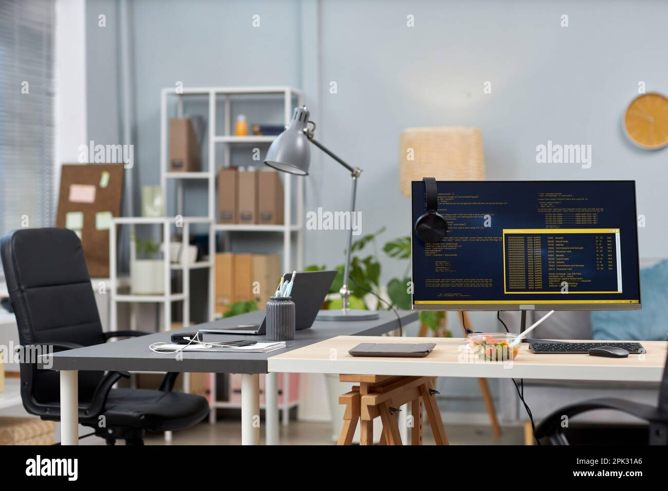 Background image of empty office with two desks and computer code on screens, copy space Stock Photo