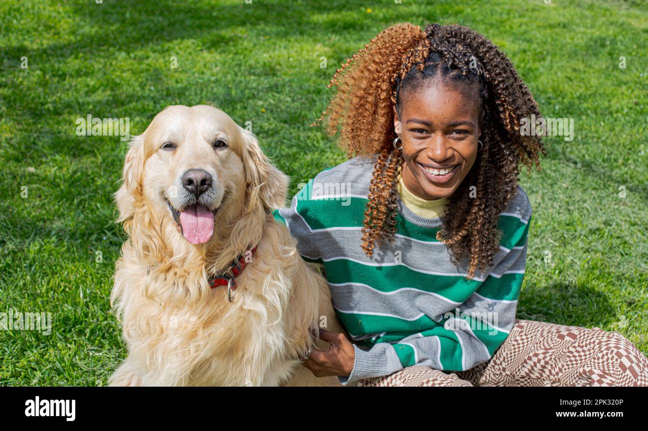 Golden retriever and african girl Stock Photo - Alamy