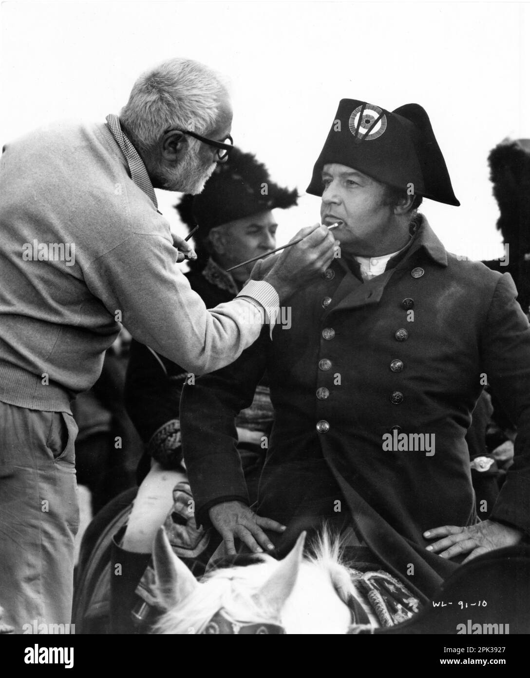 ROD STEIGER in costume as Napoleon Bonaparte has his make-up touched up by likely ALBERTO De ROSSI on set location candid in Ukraine during filming of WATERLOO 1970 director SERGEY BONDARCHUK music Nino Rota Dino de Laurentiis Cinematografica / Mosfilm / Paramount Pictures Stock Photo