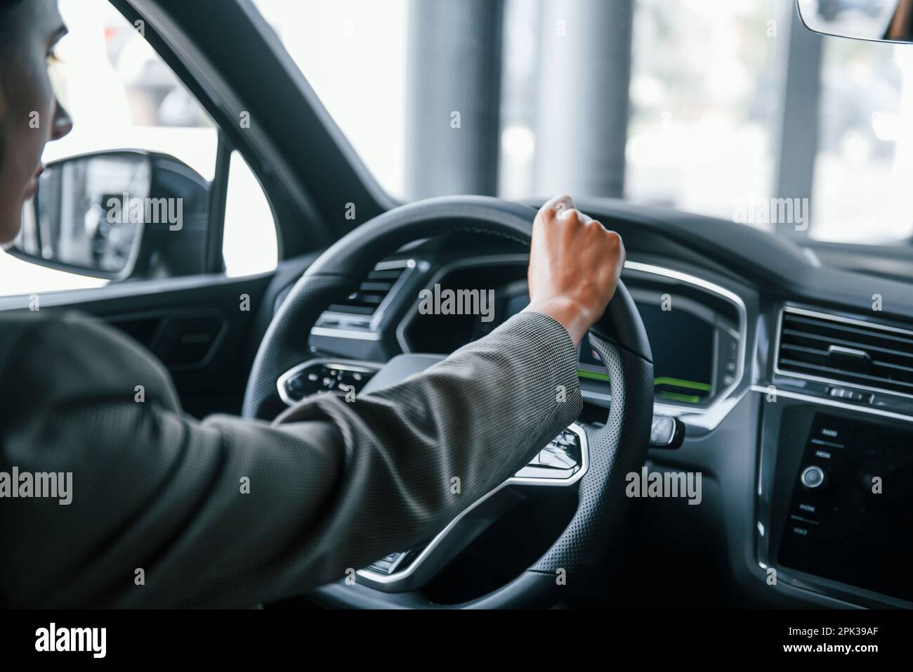 Woman sitting behind steering wheel hi-res stock photography and images ...
