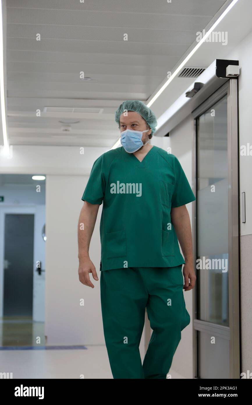 nurse in hospital corridor with surgical coveralls Stock Photo