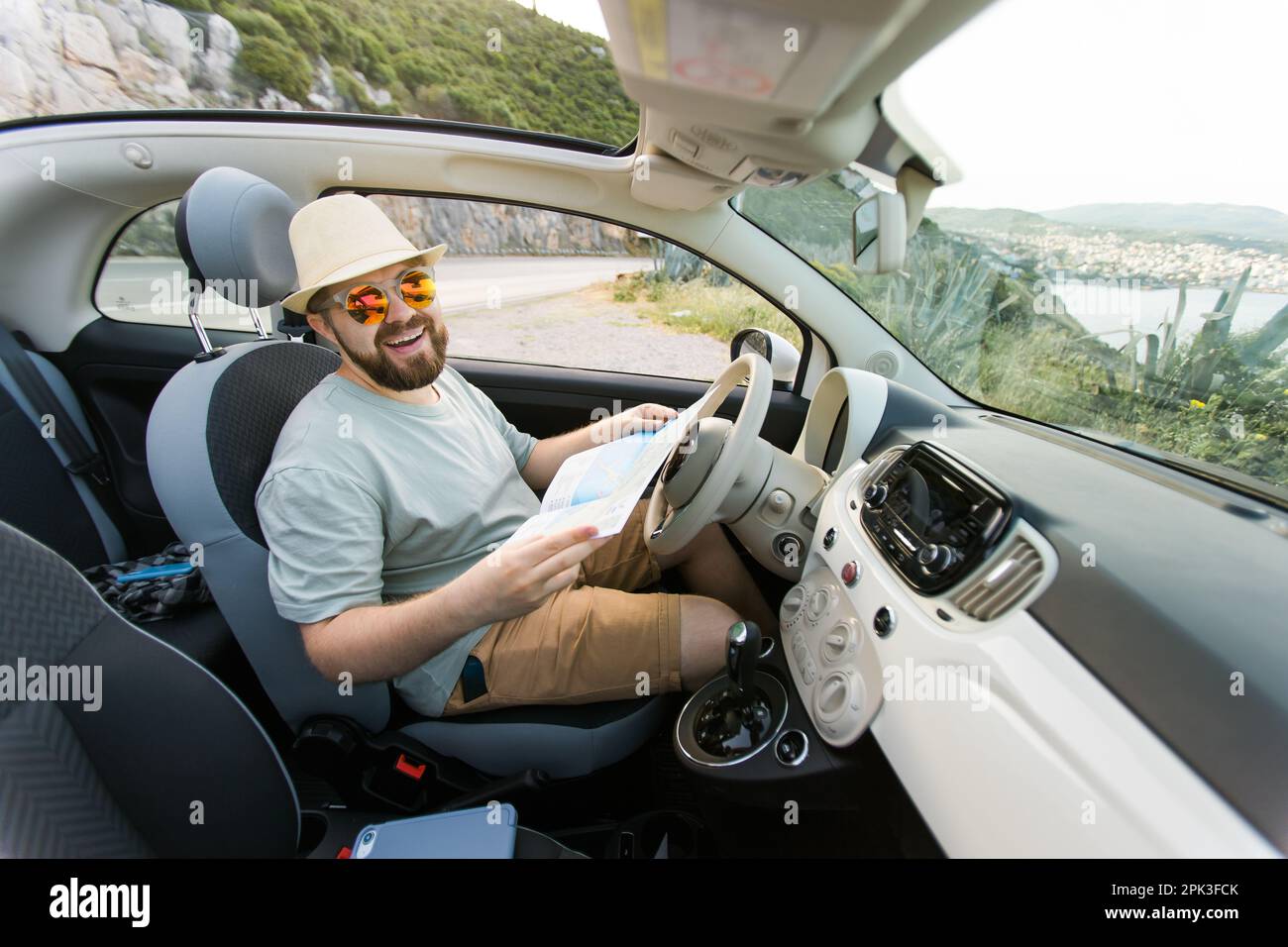 Navigate Man Hipster man looking on location navigation map in car, tourist traveler ...