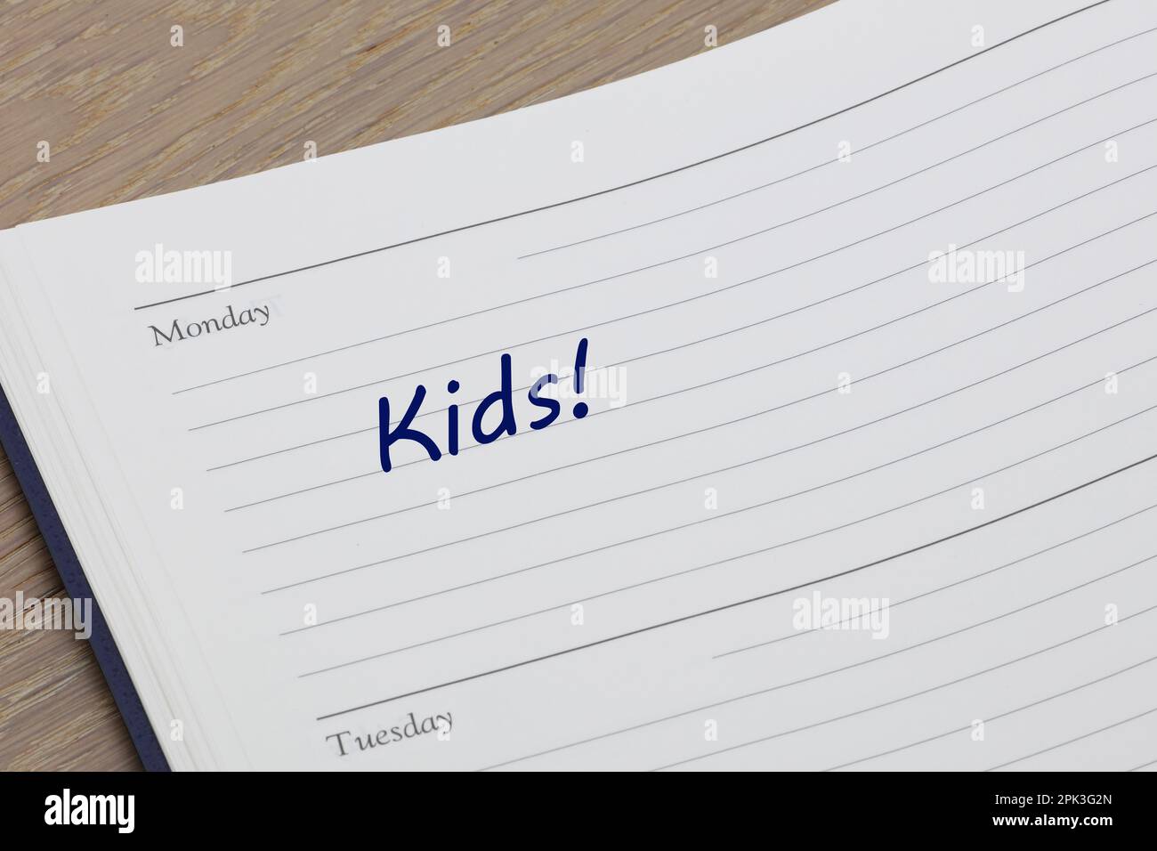 Kids reminder note in blue ink in a diary page Stock Photo