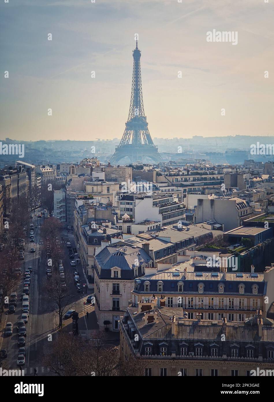 Paris cityscape with view to the Eiffel Tower, France. Beautiful parisian architecture with historic buildings, landmarks and busy city street. Aerial Stock Photo