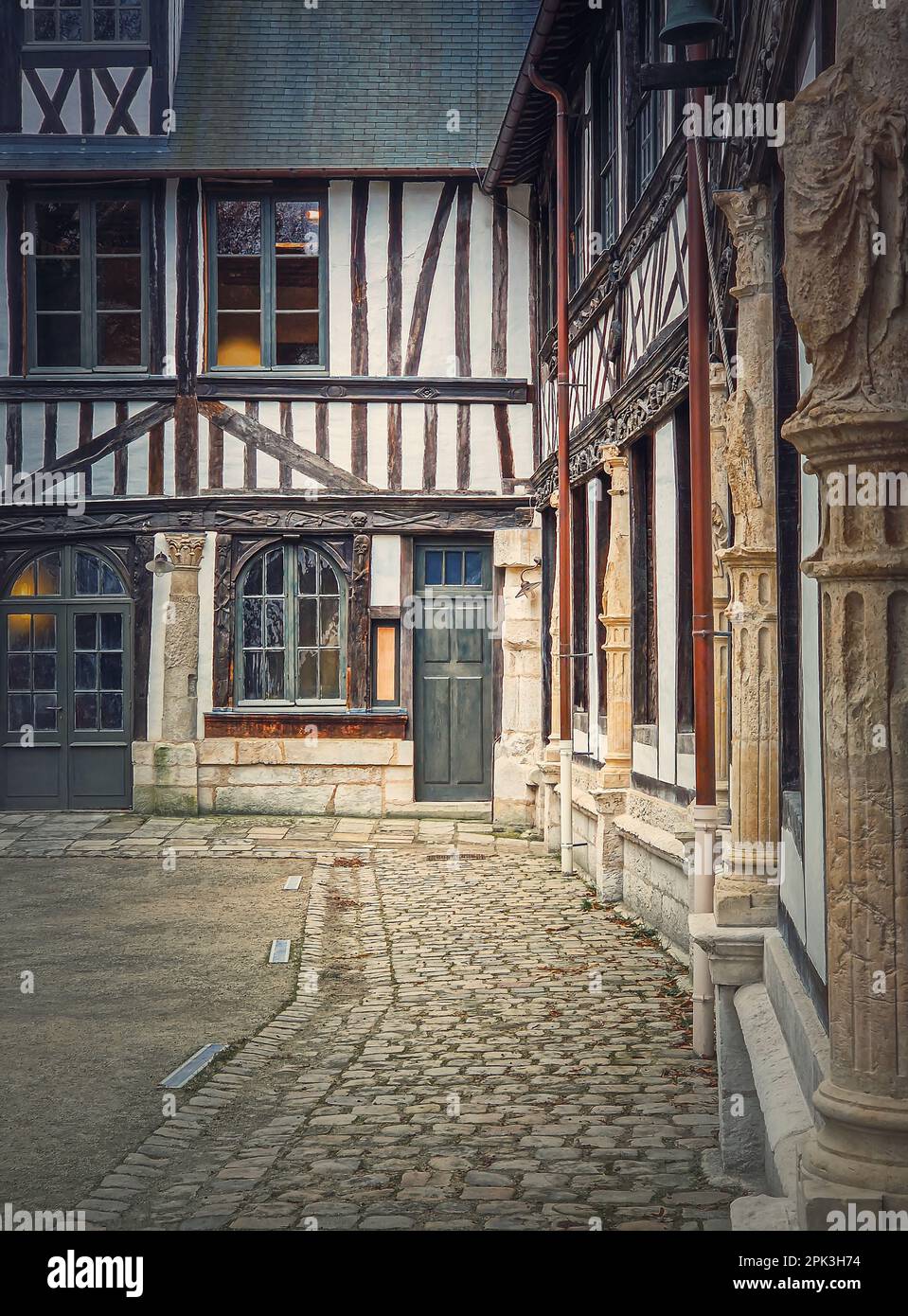 Saint-Maclou aitre, aster courtyard of medieval cemetery. Fachwerk architecture, half timbered facades details of the buildings located in Rouen, Norm Stock Photo