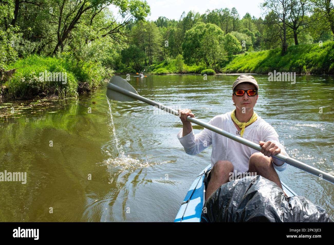 Family kayak trip. Father and daughter rowing boat on the river, a