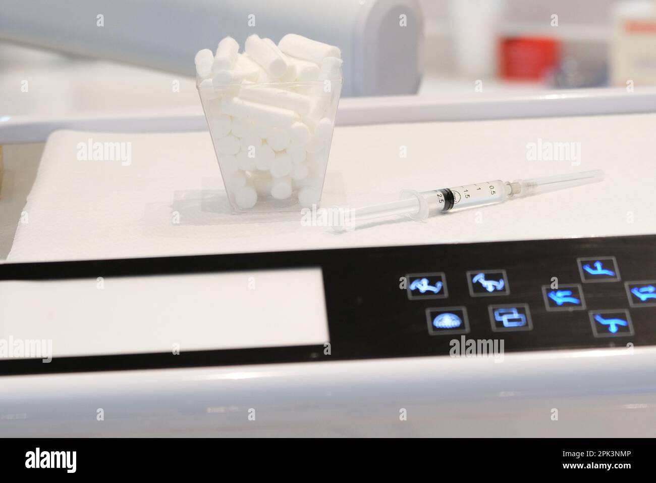Close up needle syringe and mouth cotton on dentist work ground