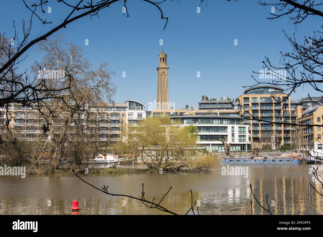 Houseboats on a placid River Thames with Kew Bridge Road housing