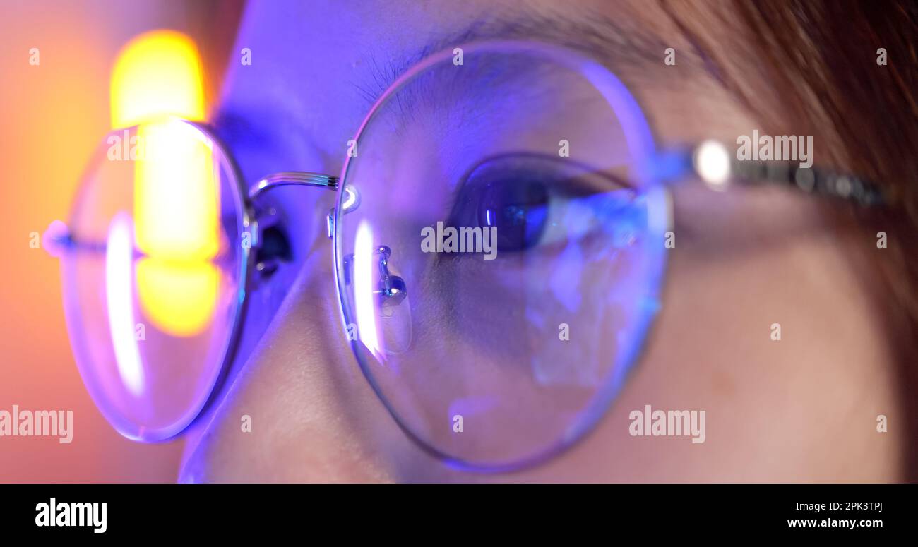 Female gamer wearing glasses for reducing eye strain blurred vision at