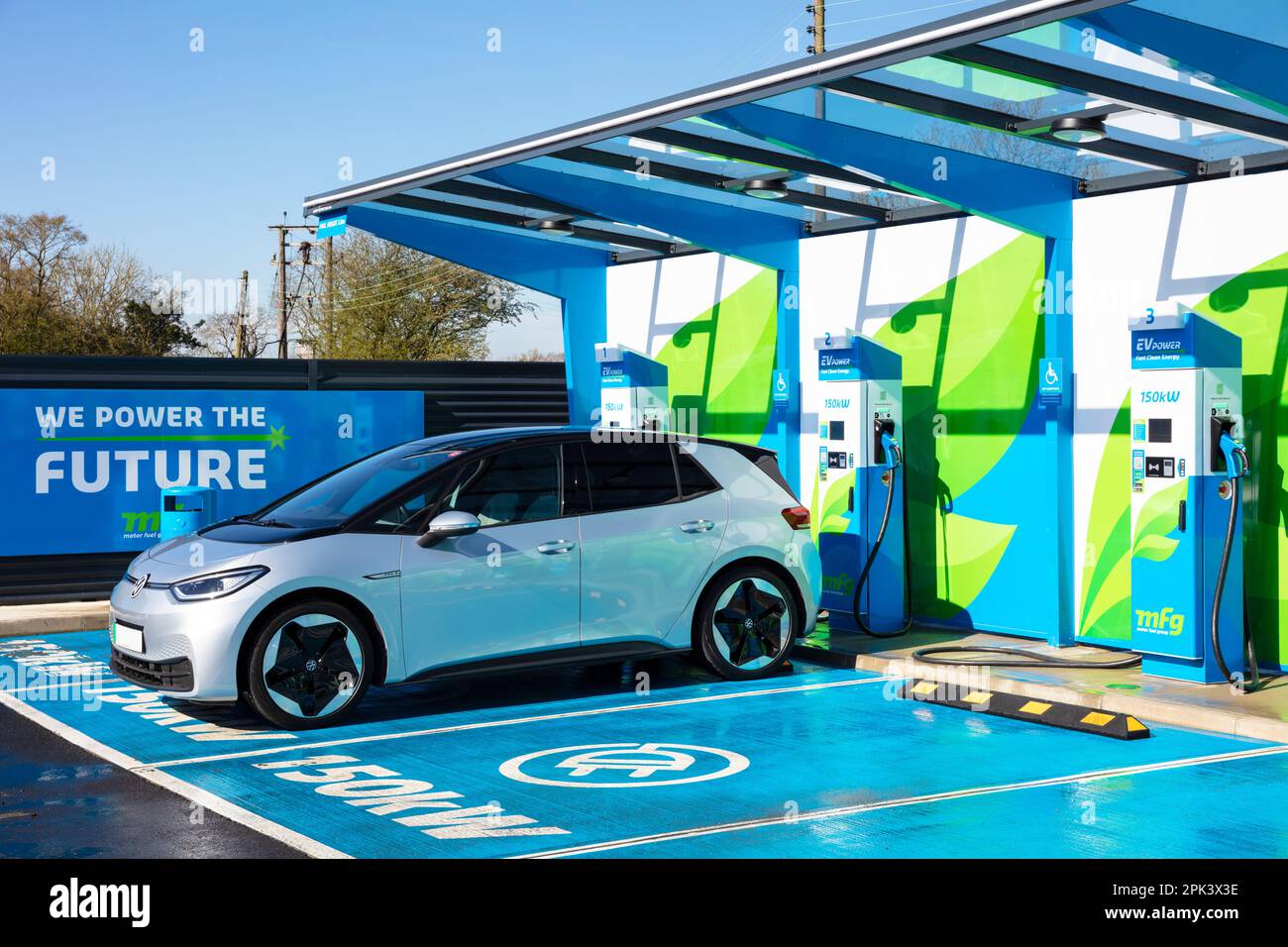 electric car UK - electric car charging at a bank of public electric car chargers in an MFG EV Power EV charging station UK electric vehicle Stock Photo