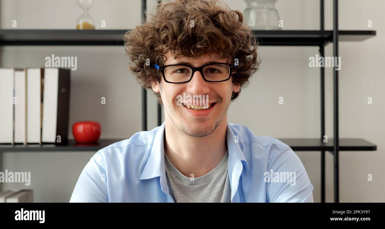 Smiling man with eyeglasses using laptop working at home Stock Photo