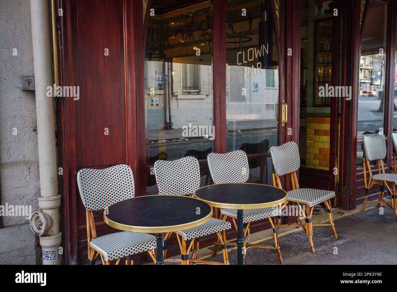 Tables and chair outside Le Clown Bar Restaurant in Paris, France. March 24, 2023. Stock Photo