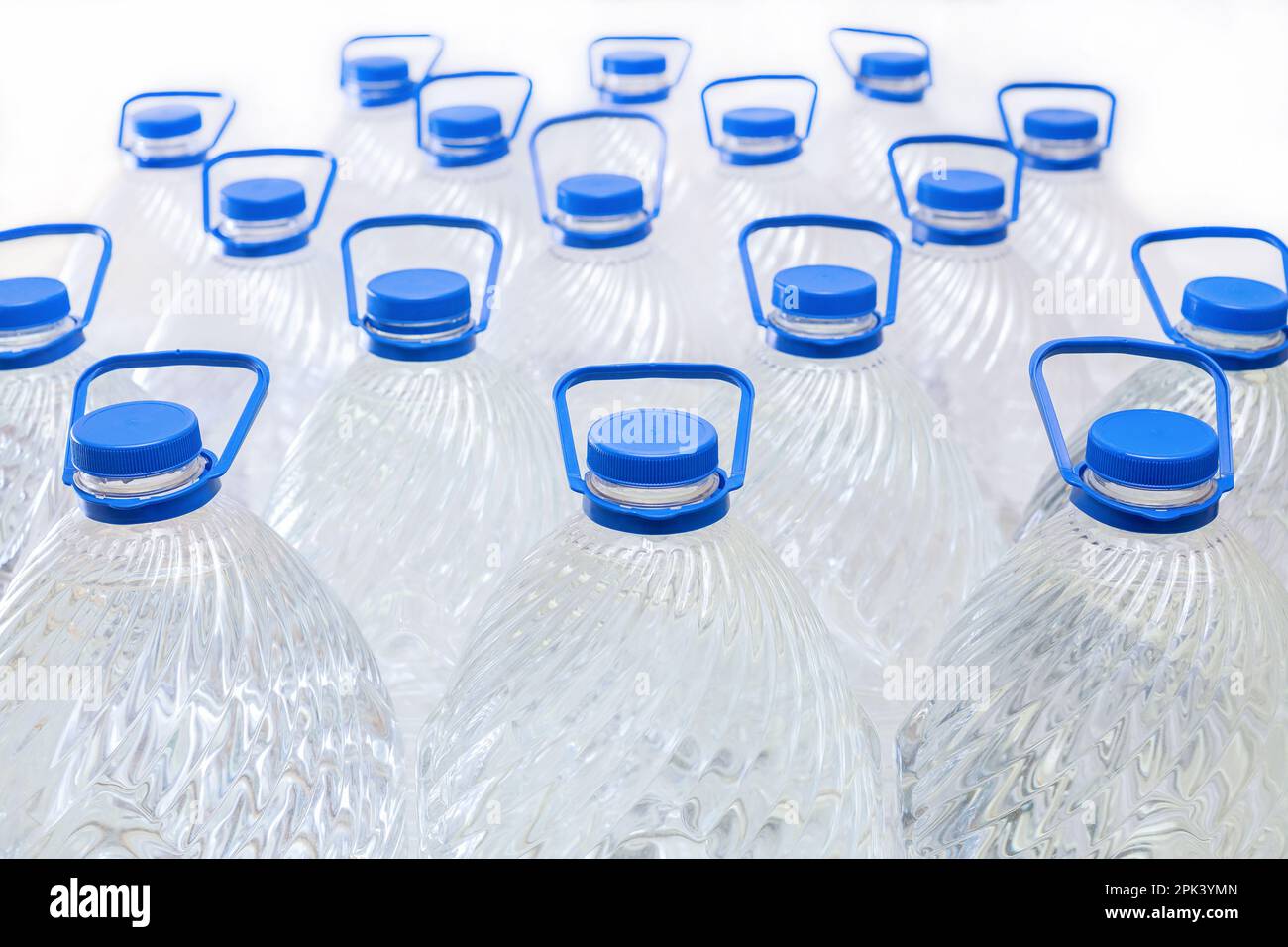 Water in plastic bottles on a white background, isolated Stock Photo