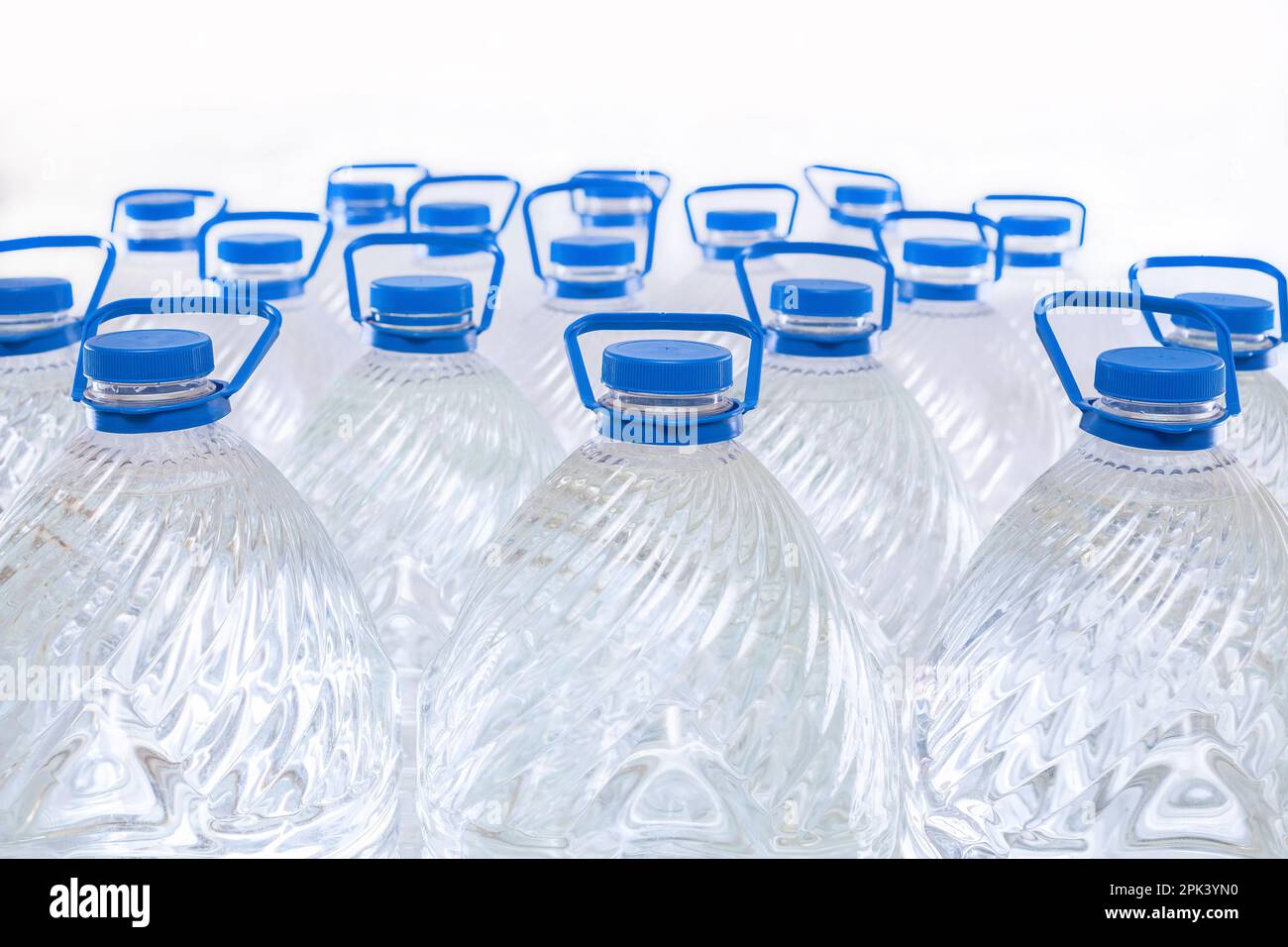 Water in plastic bottles on a white background, isolated Stock Photo