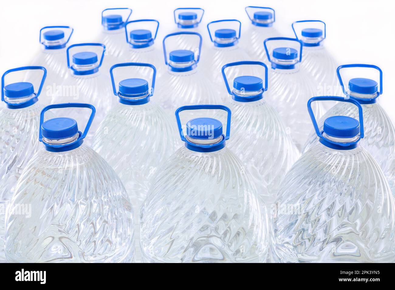 Water in plastic bottles on a white background, isolated Stock Photo