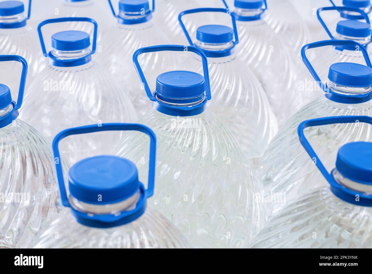 Water in plastic bottles on a white background, isolated Stock Photo