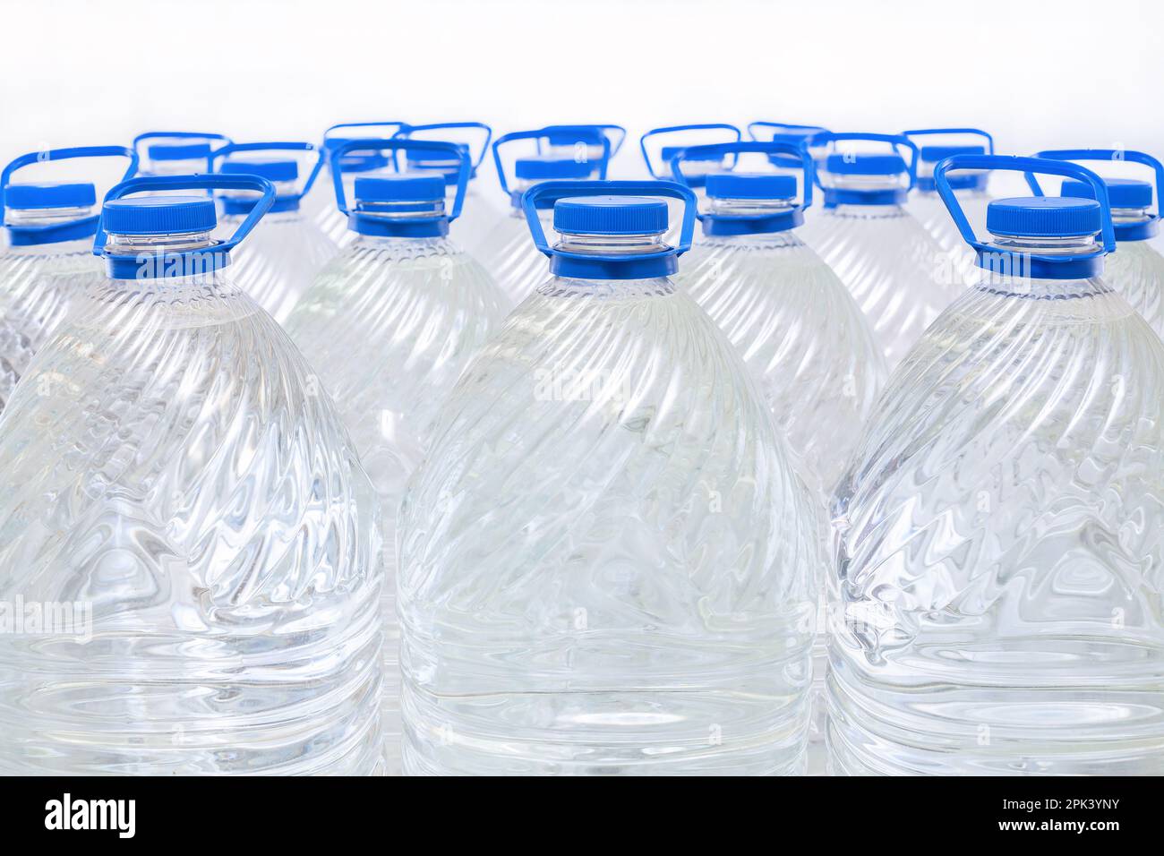 Water in plastic bottles on a white background, isolated Stock Photo
