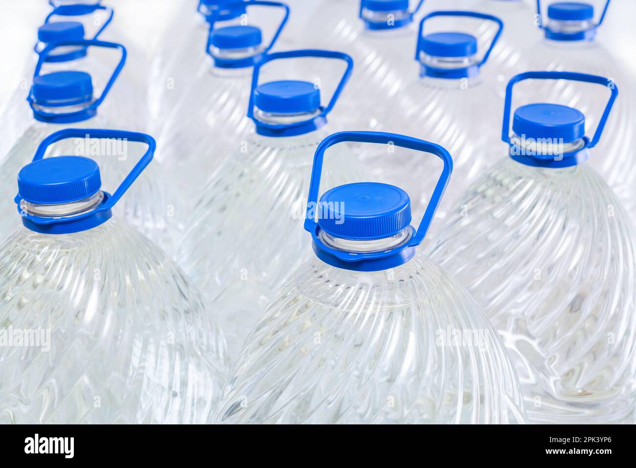 Water in plastic bottles on a white background, isolated Stock Photo