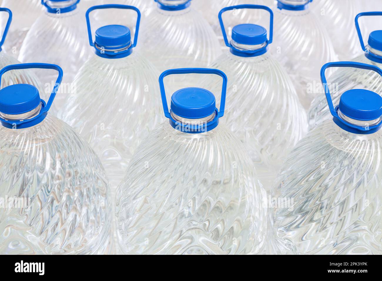 Water in plastic bottles on a white background, isolated Stock Photo