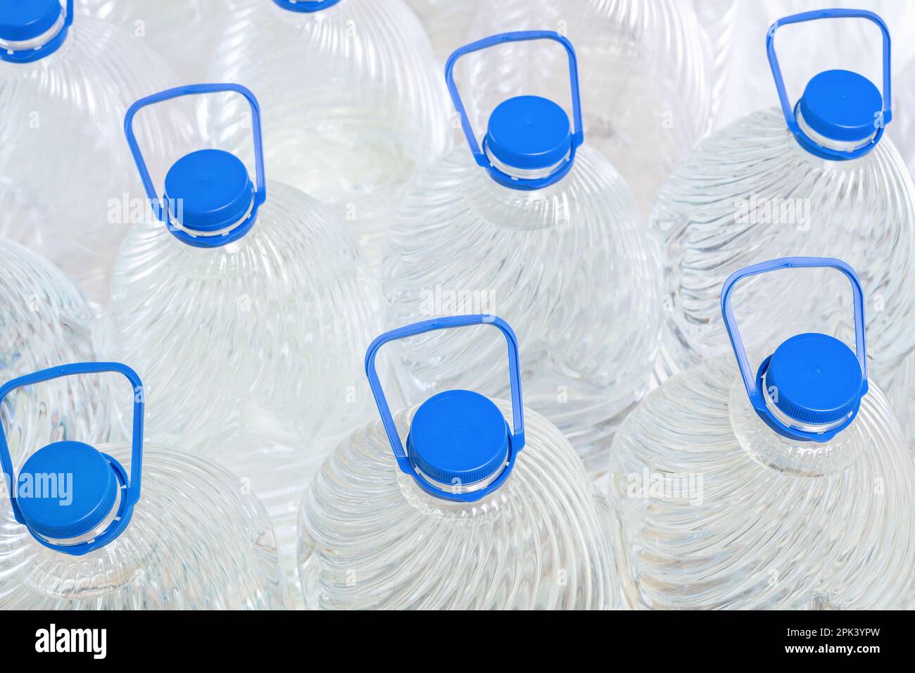 Water in plastic bottles on a white background, isolated Stock Photo