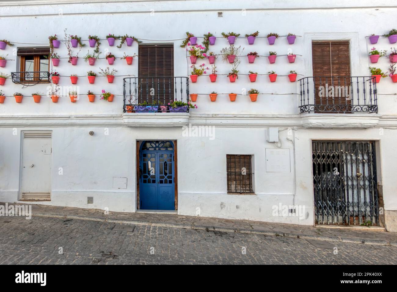 Beautiful facade decorated with pots in Vejer de la Frontera, Spain Stock Photo