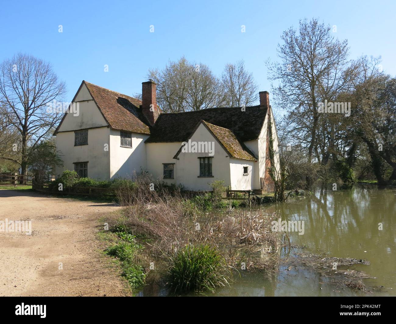 Famous from its depiction in Constable's painting 'The Hay Wain', Willy Lott's Cottage is now a Suffolk landmark owned by the National Trust. Stock Photo