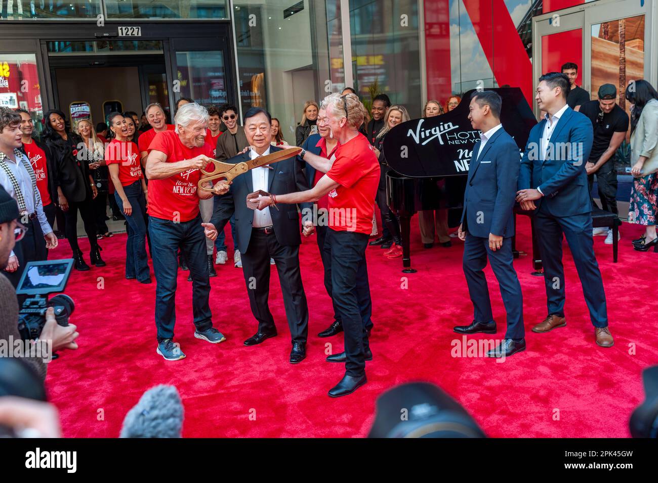 Sir Richard Branson, left, with other executives ceremoniously cuts the tie of John Lam of the The Lam Group at the Grand Opening of the Virgin Hotel New York in the NoMad neighborhood on Tuesday, April 4, 2023. (© Richard B. Levine) Stock Photo