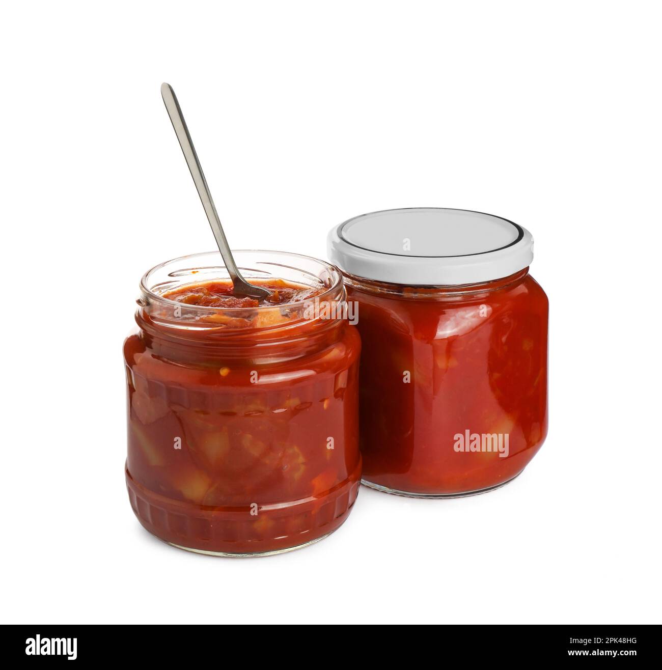 Glass jars of delicious canned lecho on white background Stock Photo