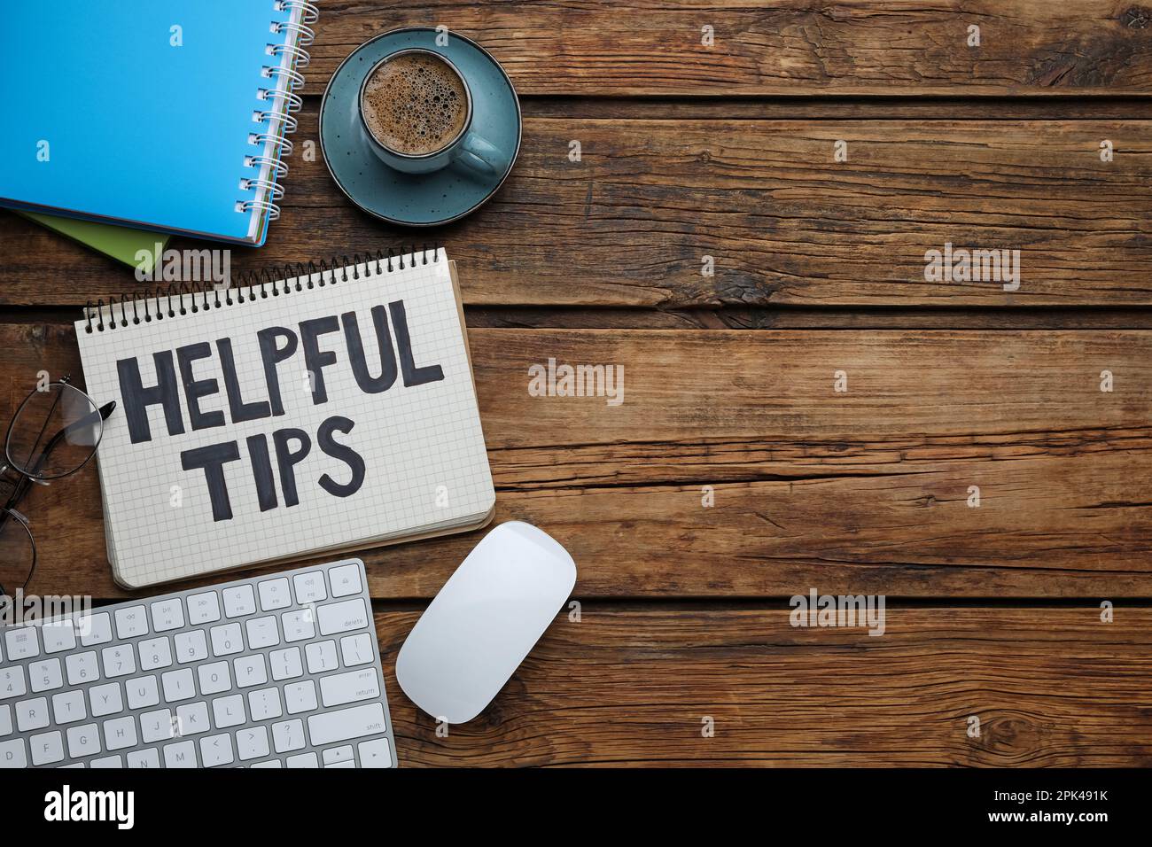 Flat lay composition with phrase Helpful Tips in notebook on wooden table. Space for text Stock Photo