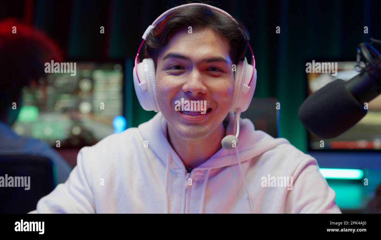 Game streamer using pc setup playing multiplayer first person shooter