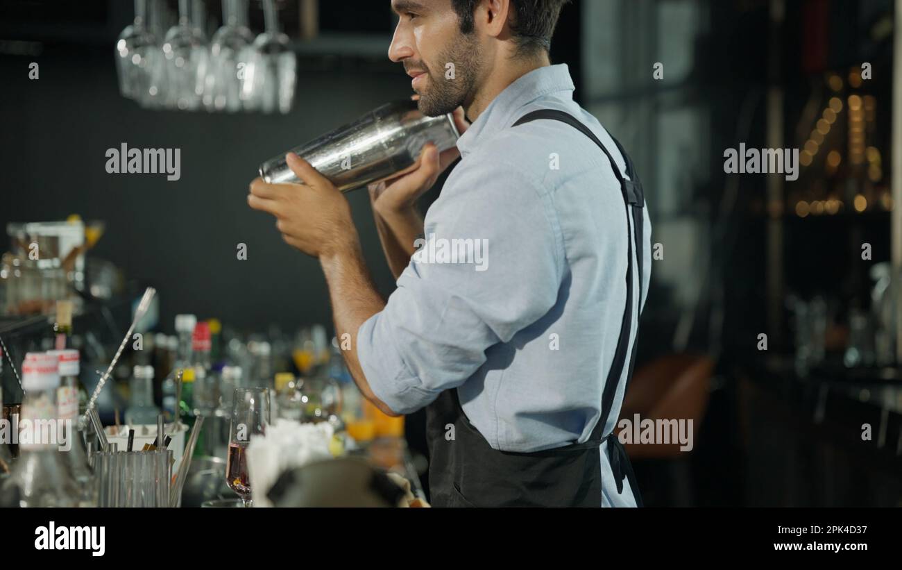 Smart bartender in black apron preparing cocktail Stock Photo Alamy