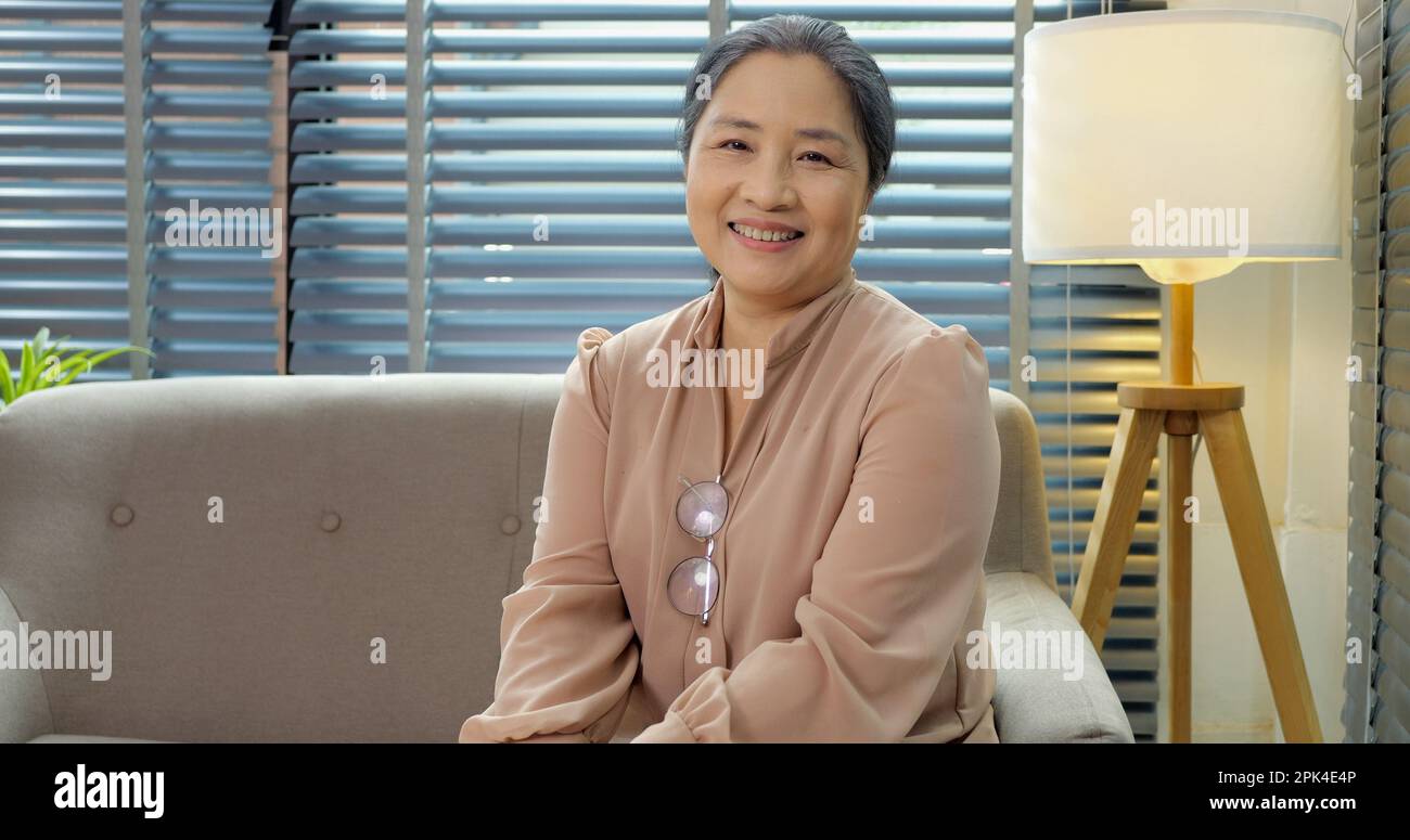 Senior woman with charming smile looking at camera making selfie Stock ...